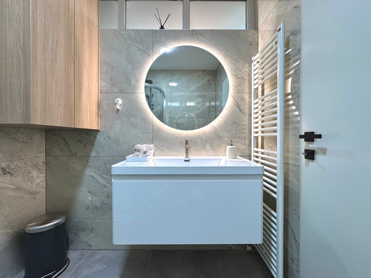 Washbasin with mirror and heated towel rail