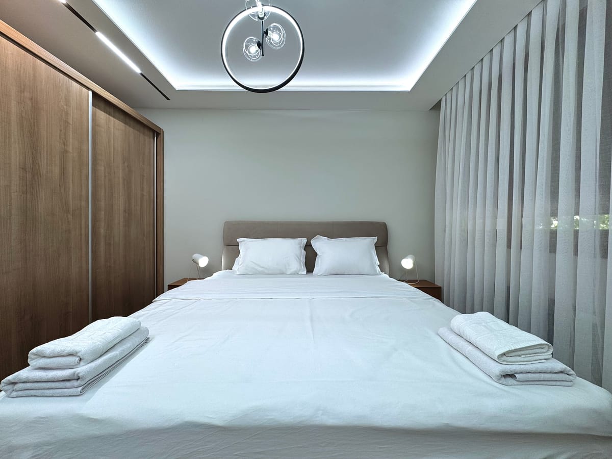 Double bed with fresh linen and towels