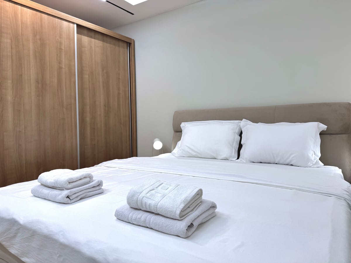 Bedroom with wardrobe and towels laid out