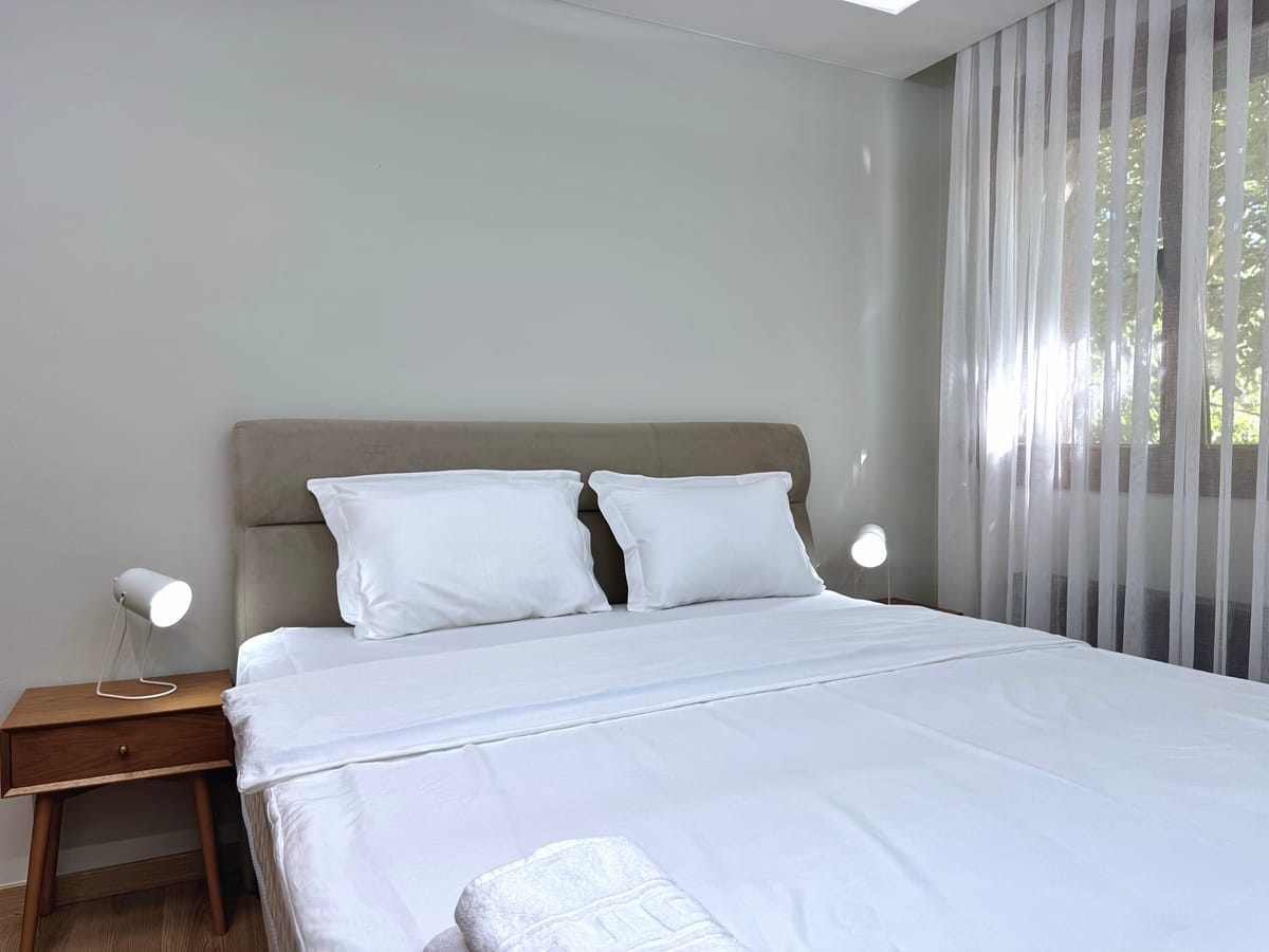 Bedroom with window and curtain