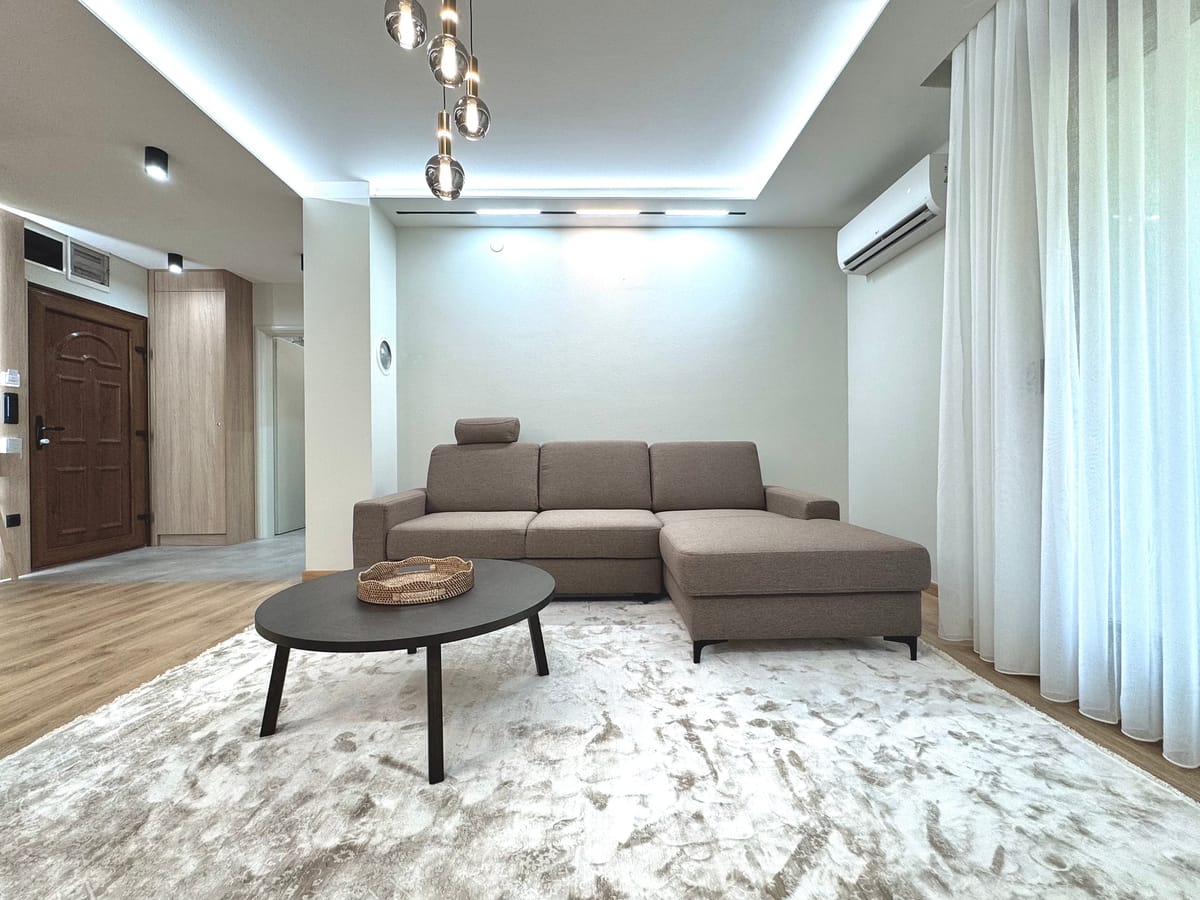 Living room with air conditioning and floor-length curtains